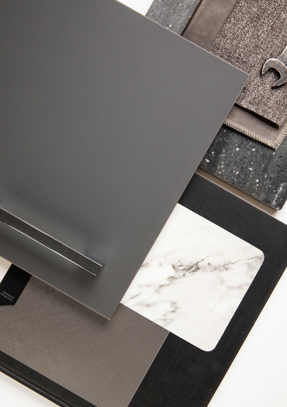Material samples of stone, wood and fabric laid out on a table
