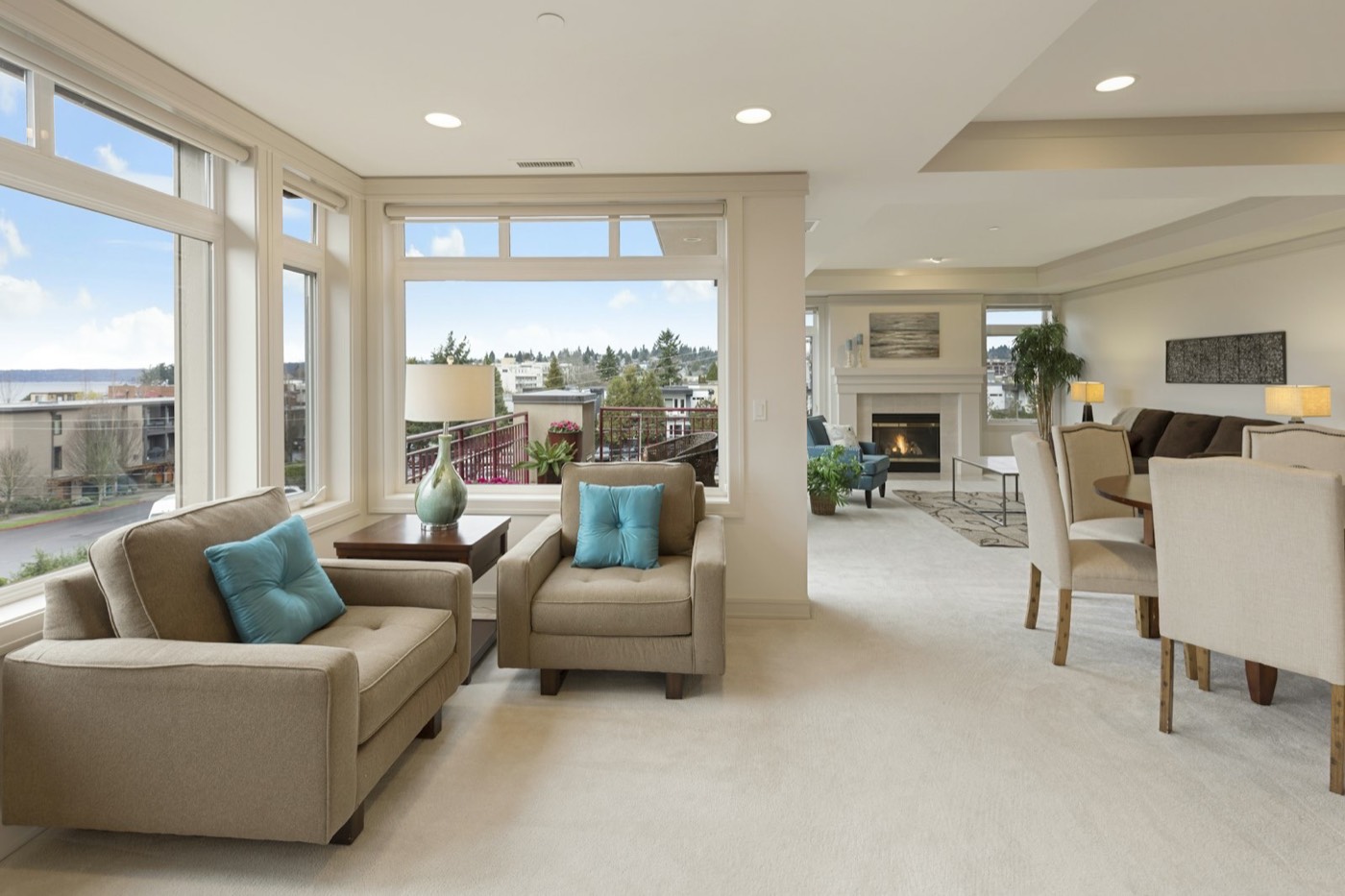An open living and dining room with wood floors and large windows